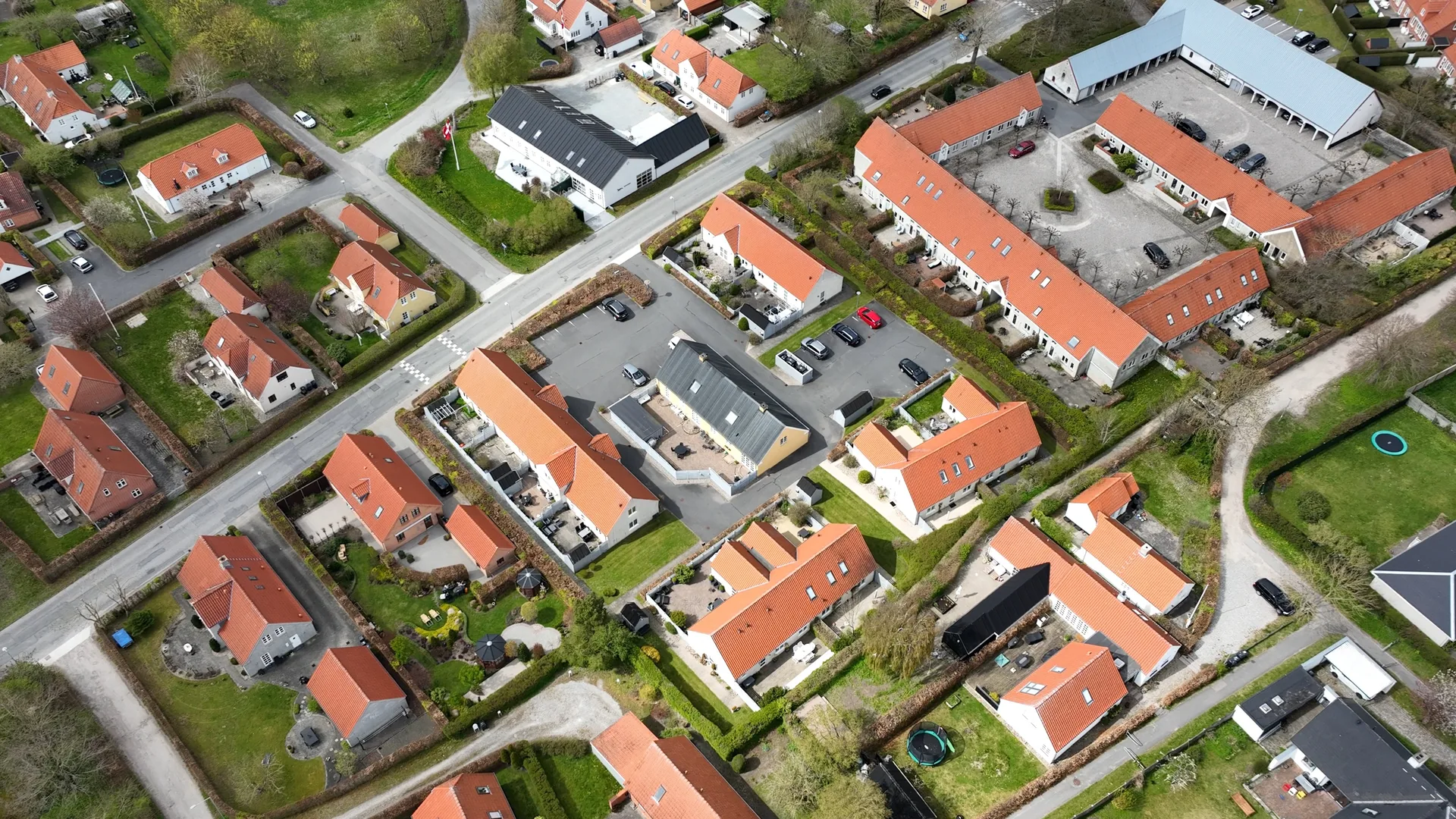 Dronefoto af ejendom i forhold til vej og naboer